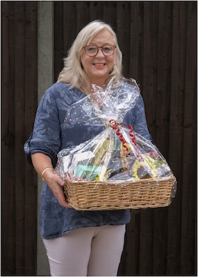 Raffle Winner receiving her prize hamper